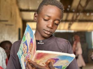 boy in Sudan reading