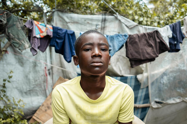 boy in Haiti sitting down