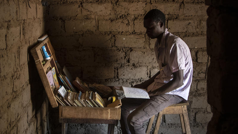 Child sitting at desk with books