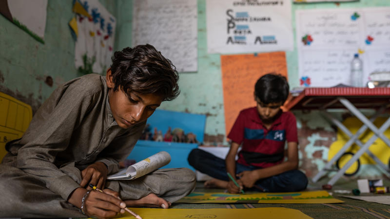 Boys in classroom writing