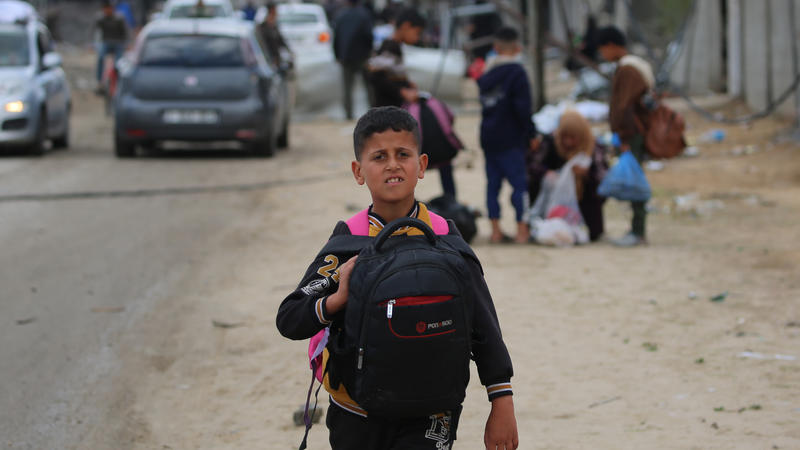 Boy with backpack in Gaza