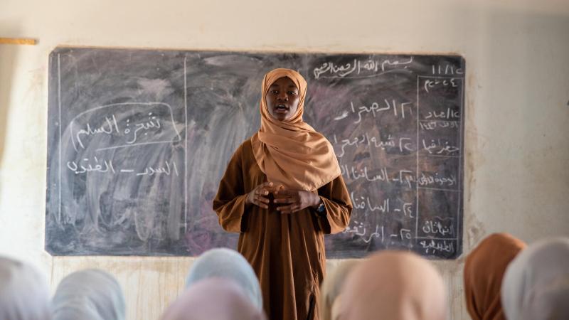 teacher in front of classroom of girls